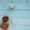 milk bottle and cookies on wood background