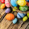 easter eggs in basket placed on wooden planks