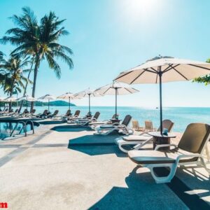 beautiful tropical beach and sea with umbrella and chair around