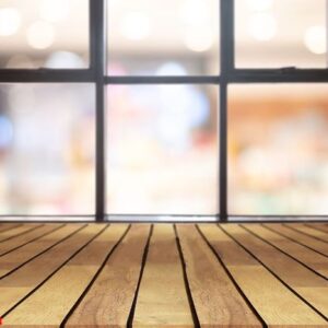 perspective wooden board empty table on top over blurred coffee