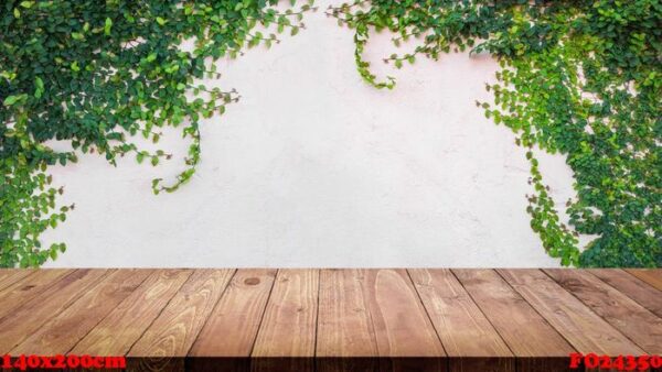 empty wood table with ivy leaves on cement wall background.