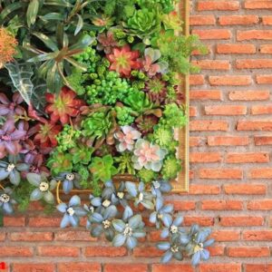 beautiful plastic flower in frame decoration on brick wall background.