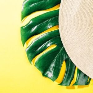 straw hat on bright yellow sunny background