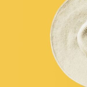 straw hat on bright yellow sunny background