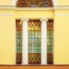 the facade of an ancient building with stained glass windows and columns. architecture