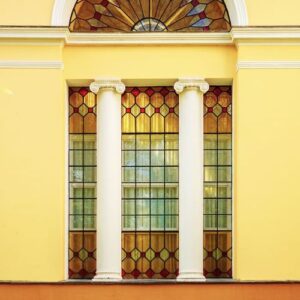 the facade of an ancient building with stained glass windows and columns. architecture