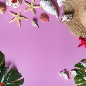 seashells on pastel violet background with straw hat summer holiday background. panton color of 2018 year