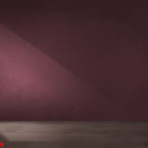 burgundy red wall in an empty room with concrete floor