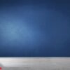 dark blue wall in an empty room with a concrete floor