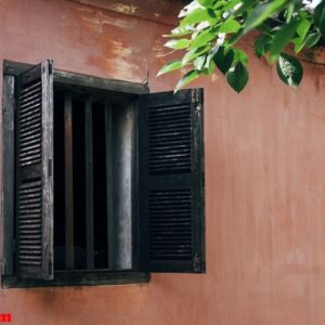 old window and pink wall in hoi an, vietnam