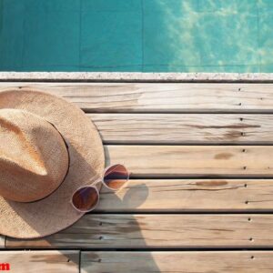 top view of poolside, sun hat and sunglasses on wooden floor