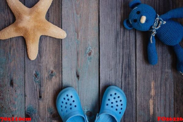 moscow, russia 05.28.2018: baby beach slippers, starfish, teddy bear on wooden background