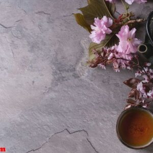 teapot and cup of tea with blossom branch