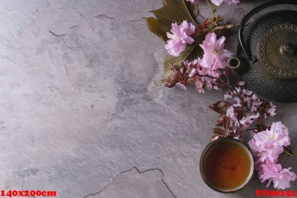 teapot and cup of tea with blossom branch