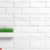 green tall grass protruding from a flower pot in the shape of a brick extended from a brick grey wall. 3d illustration