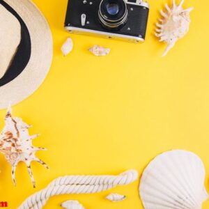 summer concept. travel accessories: a straw hat, a camera, a rop