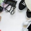 travel accessories camera, straw hat, card, shoes on a white background flat top view layout with copy space