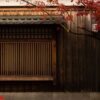 japan old house, wooden wall and window behide the meple tree and red leaf