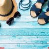 summer background straw hat bracelets sandals sunglasses seashells on a blue table copy space