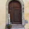 the arch door on the pale yellow wall in europe