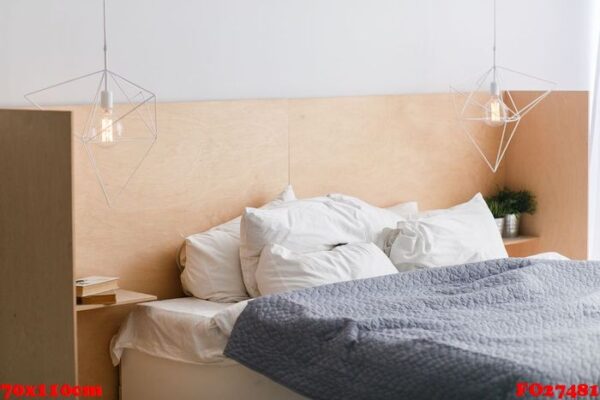 black and white bed with wooden bedhead in loft interior, geometric lights