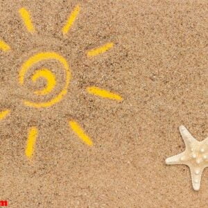 sun sign drawn and starfish, seashells on sand. creative top view copy space top view