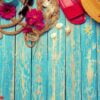 bright composition of female beach accessories on blue wooden background