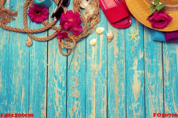 bright composition of female beach accessories on blue wooden background