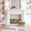 modern light interior with fireplace, spring flowers and cozy pink sofa