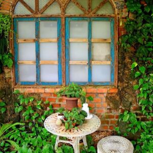 white garden table and chair with mini planters in the backyard