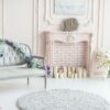 elegant pink pastel fireplace decorated with spring flowers, candles.