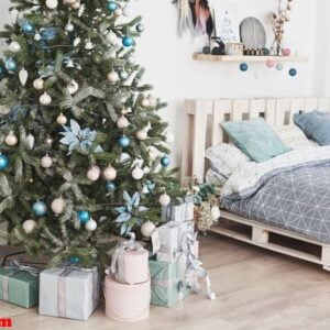 beautiful holdiay decorated room with christmas tree with presents under it