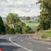 beautiful australian road crossing a green landscape.