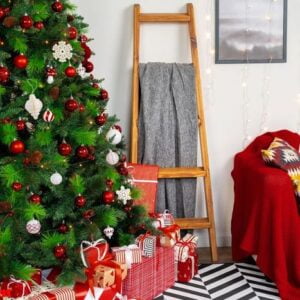 beautifully decorated christmas room with fir tree and white sofa