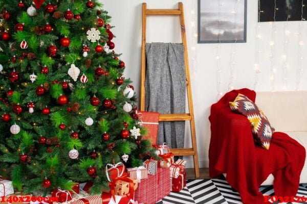 beautifully decorated christmas room with fir tree and white sofa