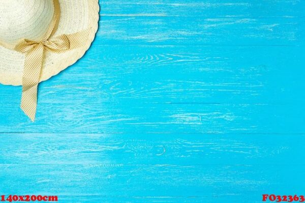 frame elegant female straw hat on blue wooden background, copyspace for text, summer vacation.