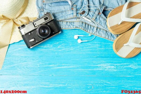 frame elegant female straw hat slippers jeans camera on blue wooden background, copyspace for text, summer vacation.