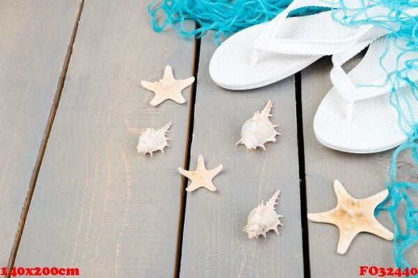 seashells and white flip flops grey wooden background. flat lay.