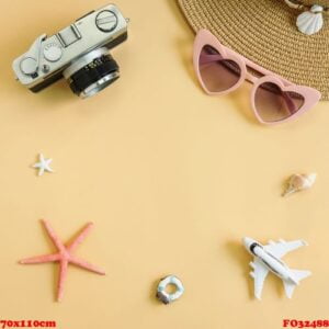 beach hat with camera and travel items on yellow background, summer vacation concept