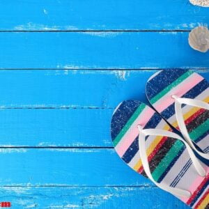 pair of female beach slippers on a blue background