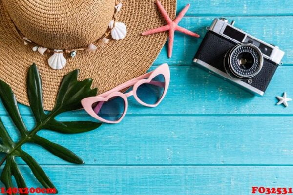 travel accessories items on wooden background, summer vacation concept