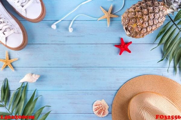 summer flat lay background. palm leaves, shoes, pineapple, headphones, hat and starfish on blue woodwn background.