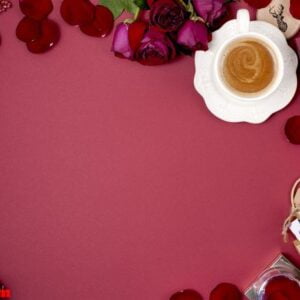 a cup of fragrant coffee and new year decor on a red background.