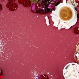 a cup of fragrant coffee and new year decor on a red background.