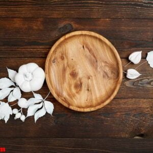 wooden place with white berries and leaves on a wooden mock up autumn background. greeting card for thanksgiving day in rustic style with space for your text. flat lay. top view