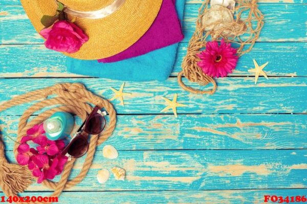 bright composition of female beach accessories on blue wooden background