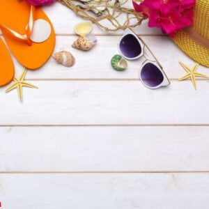 beachwear and accessories on a white wooden background