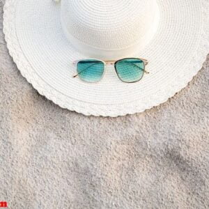 hats and glasses are located on the sea blue sea beaches on a clear day