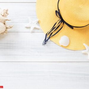 top view of summer yellow female hat with sunglasses and shell a