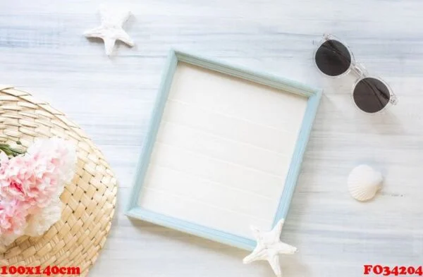 top view of summer blue picture frame with sunglasses and seashe